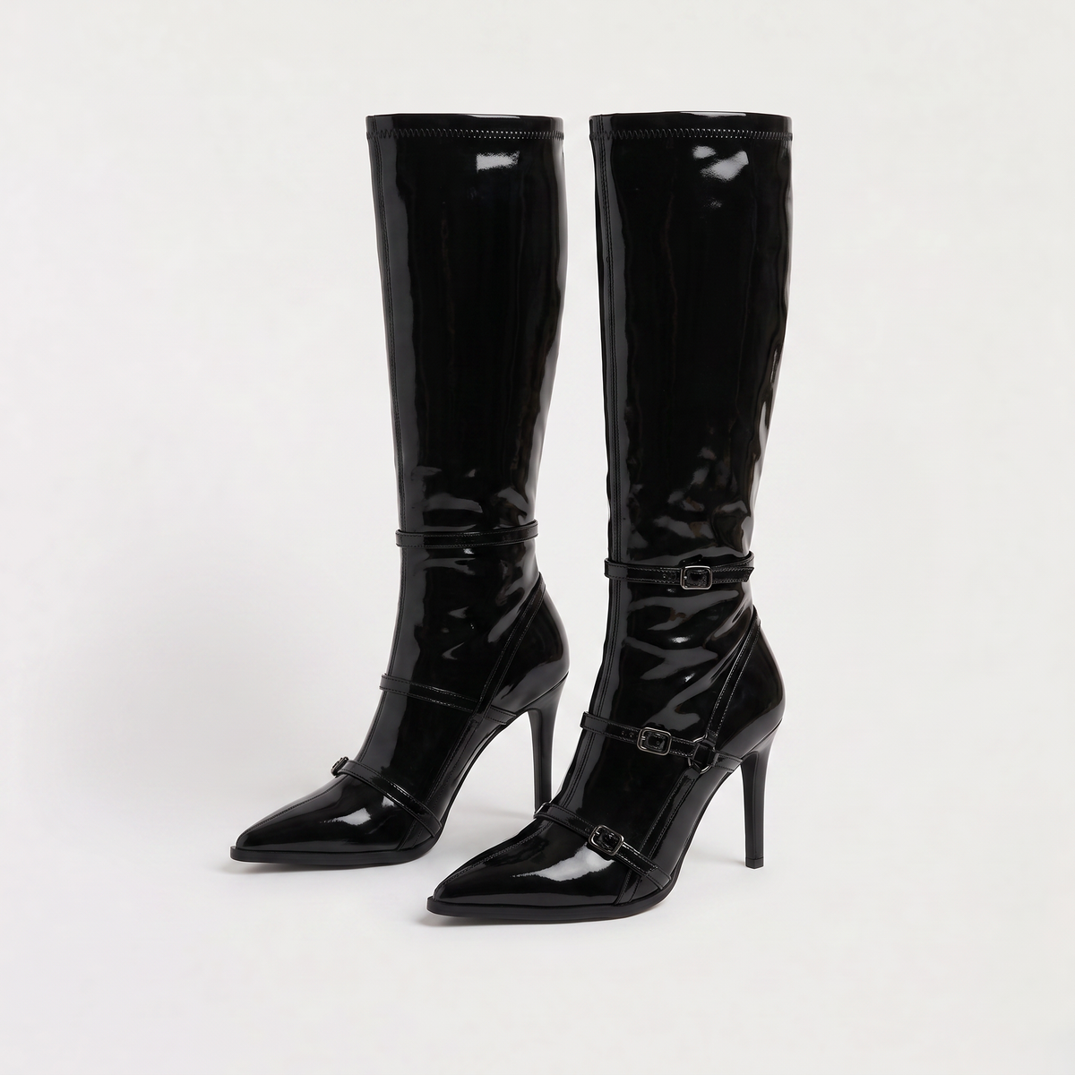 Black knee high boots featuring a sleek patent finish, inner zip closure, and stylish buckled straps, designed with elegant stiletto heels for women. 4