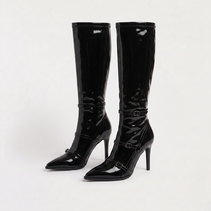 Black knee high boots featuring a sleek patent finish, inner zip closure, and stylish buckled straps, designed with elegant stiletto heels for women. 4