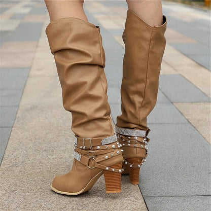 Black knee high boots featuring studded straps and a block heel, crafted from slouchy vegan leather for a stylish and comfortable fit for women. 5