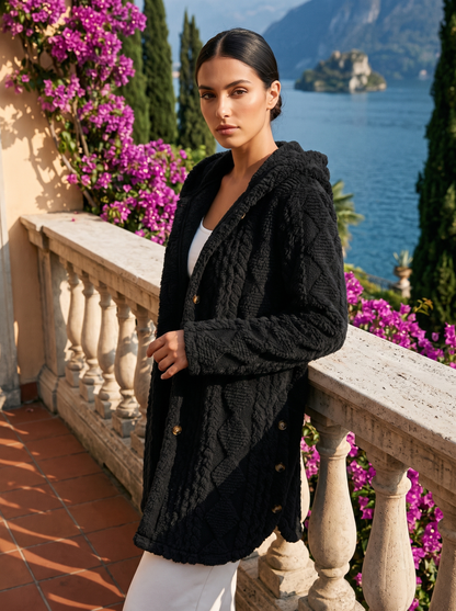 Woman wearing a black plush hooded longline cardigan on a Lake Como terrace — Aveloire